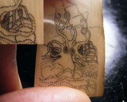 Kraken scrimshaw on mammoth ivory with detail callout to the upper left