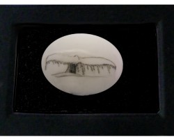 Scrimshaw of a Whale's tale breaking the surface of the water