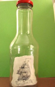 Scrimshaw of a ship in full sail in a bottle