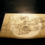 kraken scrimshaw viewed sideways and at a slight angle to show the lines