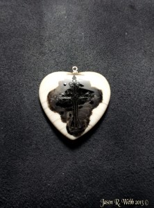 Cross on side two of the scrimshaw heart inked.