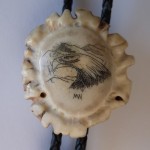 Bolo Closeup of eagle head with initials MN - mystery artist #10 - scrimshaw.com