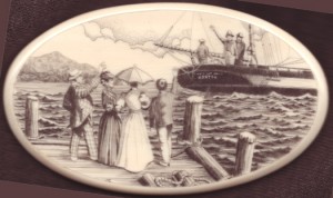Scrimshawed harbor scene by Michael Cohen with a ship setting sail and people waving from the dock