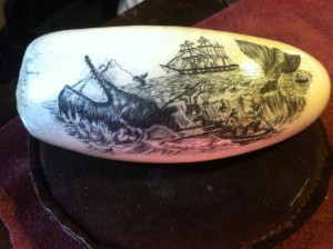 scrimshaw of a whale with a ship in the background