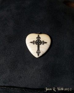 Scrimshaw Cross on side two of an ancient ivory heart by Jason R. Webb