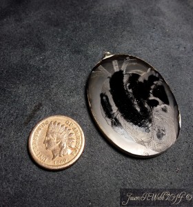 Coin to the left and the inked cabochon to the right