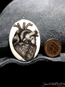 Scrimshaw Heart ivory pendant on the left, coin on the right. (C) 2014 by Jason R. Webb