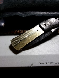 Damascus folder with the bone handle removed and Jason's careful cleaning about half way through