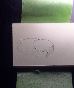 Stippling of the Buffalo in progres on paper micarta.  Hind portion outline stippling completed, front portion not finished.