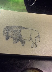 Buffalo scrimshaw on paper micarta in progress