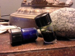 Tipped ink vial (left) and one with poster putty on the bottom holding it fast.
