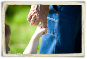 Small hand holding Grandpa's finger