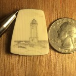 Lighthouse scrimshaw on galalith with a quarter to the right to show the scale
