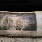 Closeup of two battling ships scrimshawed on one of the tusks from Mystery Artist 23