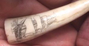 Scrimshaw of a ship on an antler tip