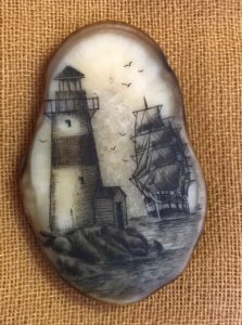 Lighthouse and Ship on walrus ivory, small cursive "L" to the right